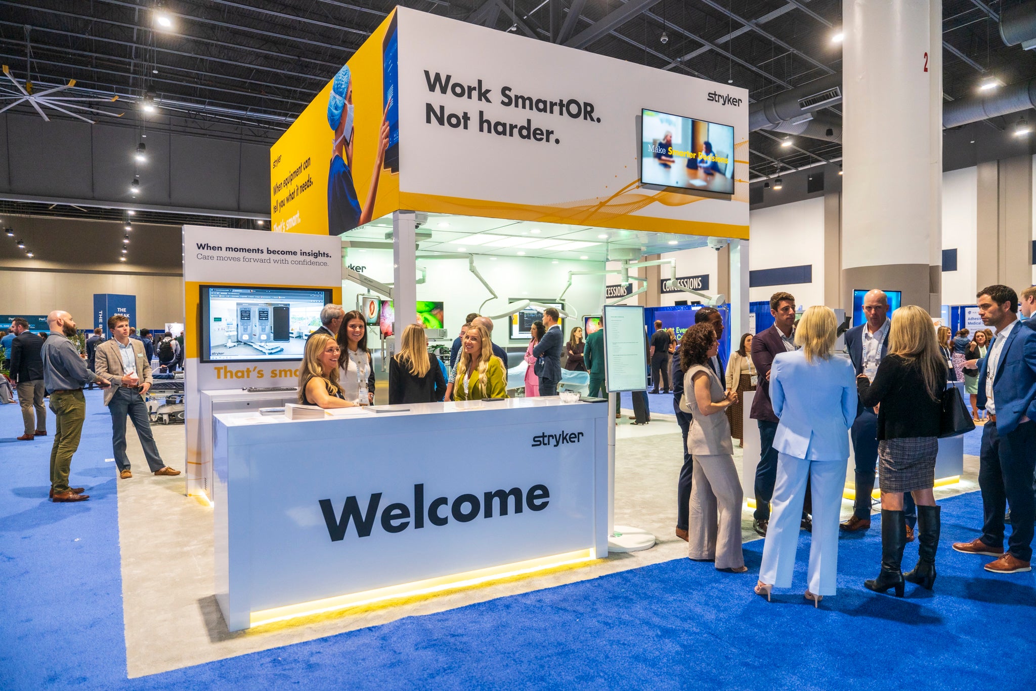 Attendees gathered around an exhibitor booth in the Hall