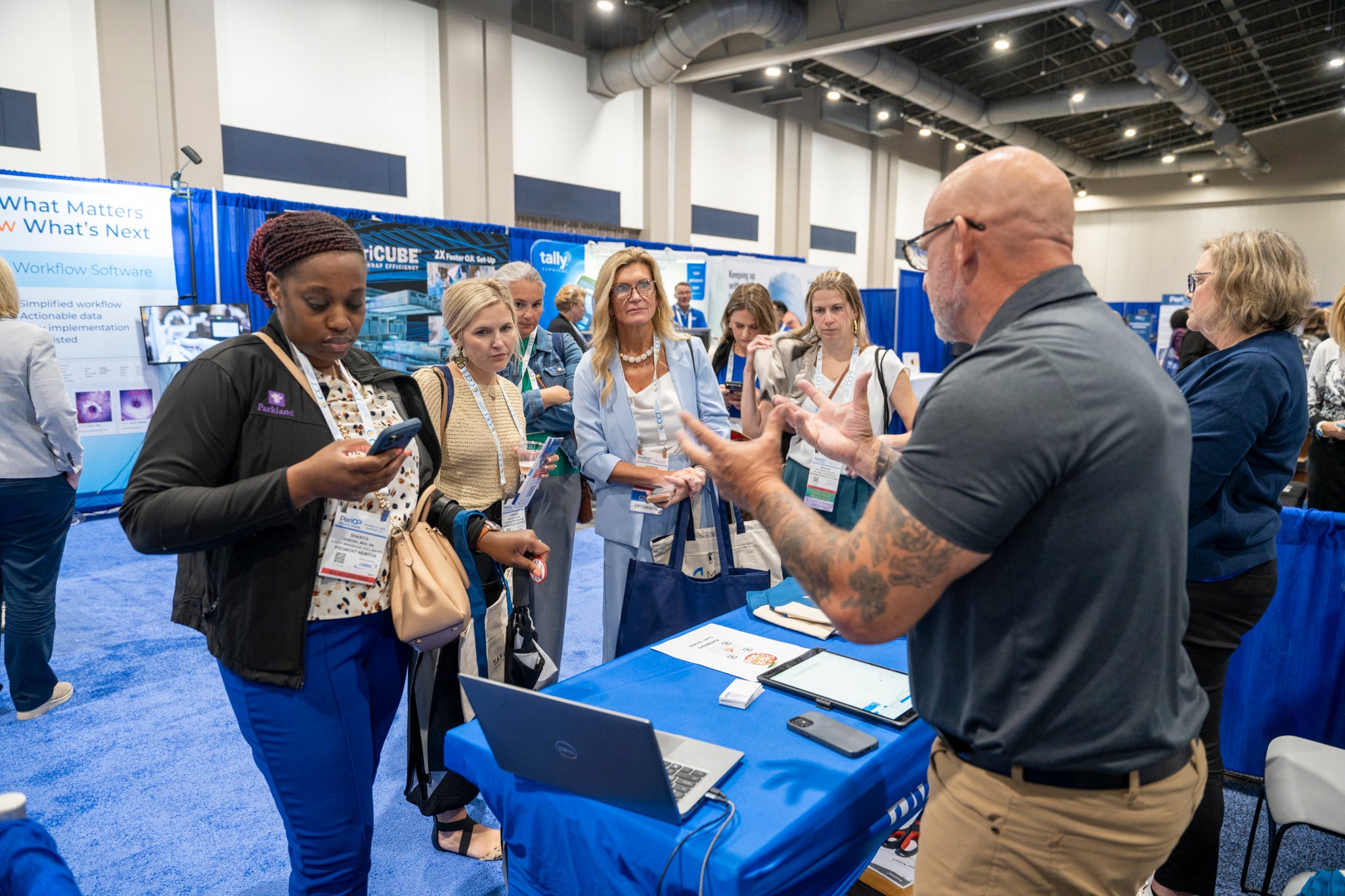 Attendees listening to an exhibitor demonstration